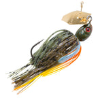 Dark green chatterbait lure with red eye and skirt with orange accent strands