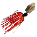 ChatterBait lure with red skirt and dark head, gold metal blade with treble hooks.