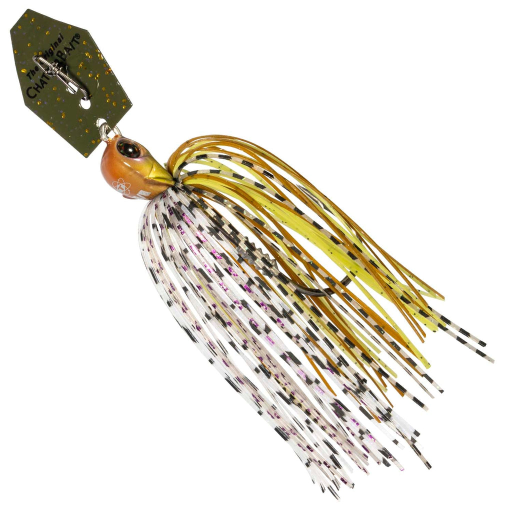 Chatterbait fishing lure with golden skirt and white highlights, green-brown accents, hook